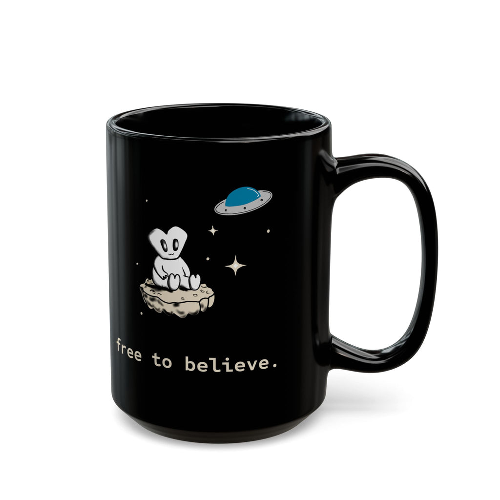 Alien Sitting on Rock Black Mug — “free to believe.” 11oz & 15oz